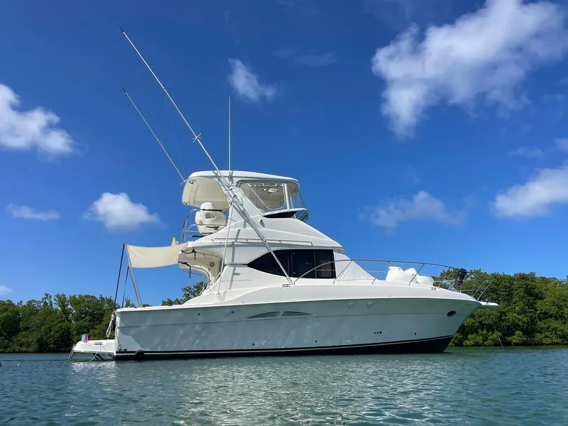 Slide: The Image of 2007 Silverton 38 Convertible yacht on calm water under blue sky. - 0