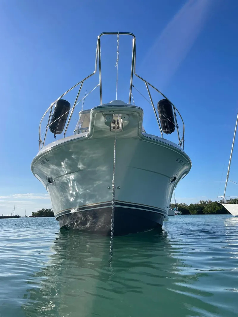 Slide: The Image of 2007 Silverton 38 Convertible boat on calm water under clear blue sky. - 1