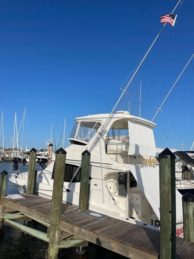 Slide: The Image of 2007 Silverton 38 Convertible yacht docked at marina under clear blue sky. - 11