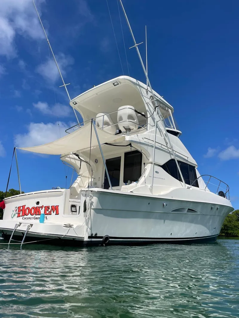 Slide: The Image of 2007 Silverton 38 Convertible yacht on clear water under blue sky. - 12