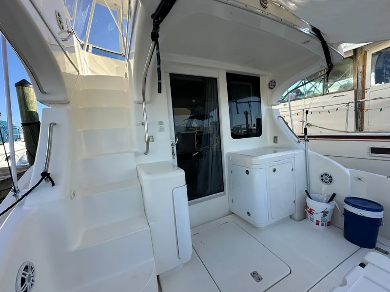 Slide: The Image of 2007 Silverton 38 Convertible yacht deck with stairs and storage area. - 13