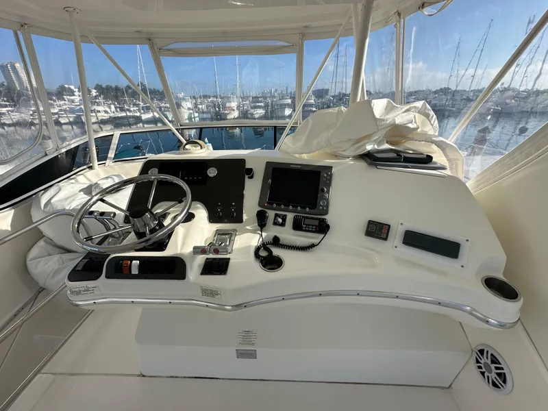 Slide: The Image of 2007 Silverton 38 Convertible yacht helm with navigation equipment and marina view. - 14