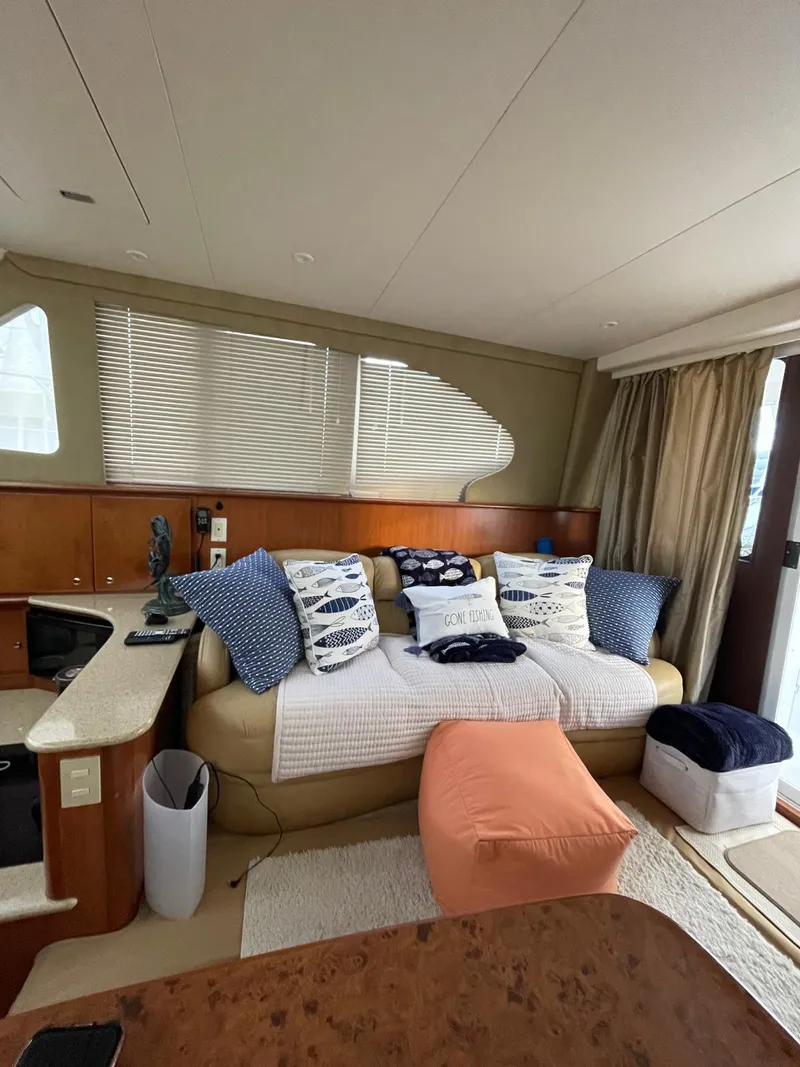Slide: The Image of Interior of 2007 Silverton 38 Convertible yacht with cozy seating and nautical decor. - 15