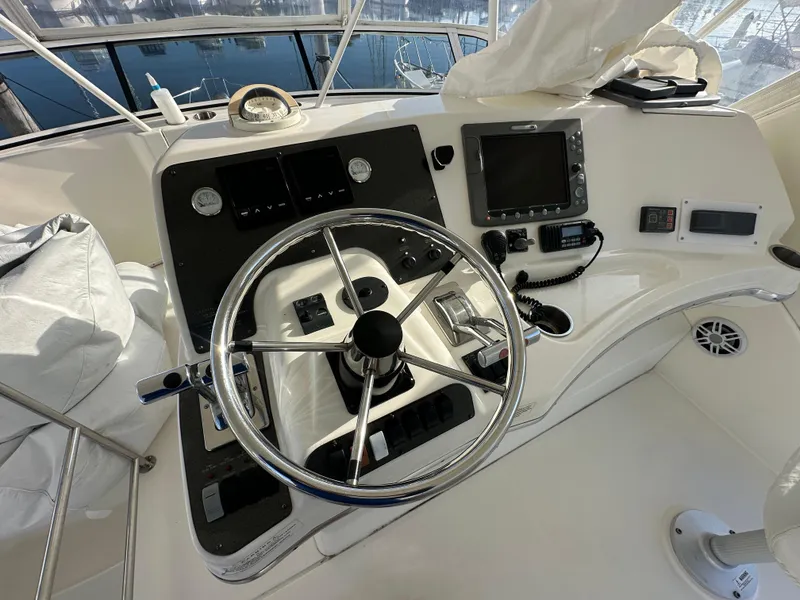 Slide: The Image of 2007 Silverton 38 Convertible yacht helm with steering wheel and navigation controls. - 16