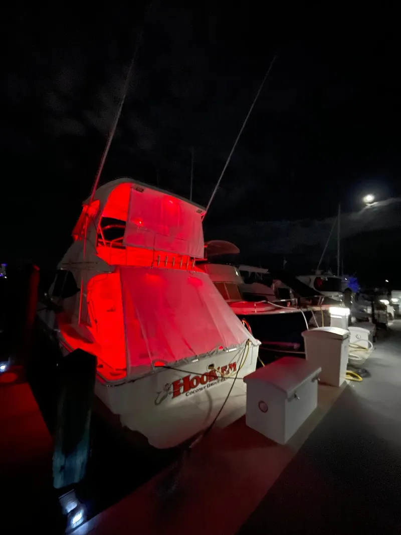 Slide: The Image of 2007 Silverton 38 Convertible boat illuminated at night in marina. - 2