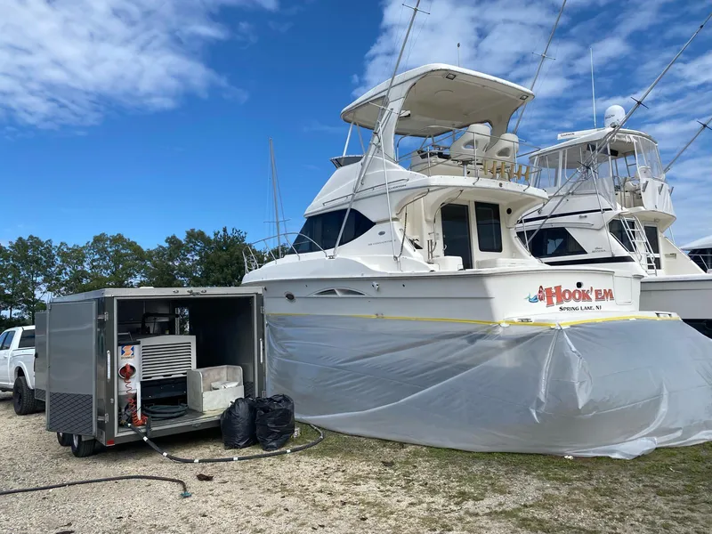 Slide: The Image of 2007 Silverton 38 Convertible yacht in dry dock with maintenance equipment nearby. - 22