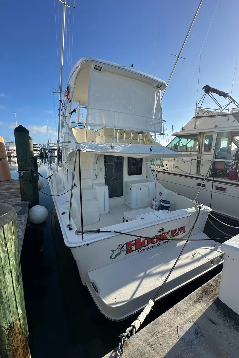 Slide: The Image of 2007 Silverton 38 Convertible yacht docked at marina under clear blue sky. - 26