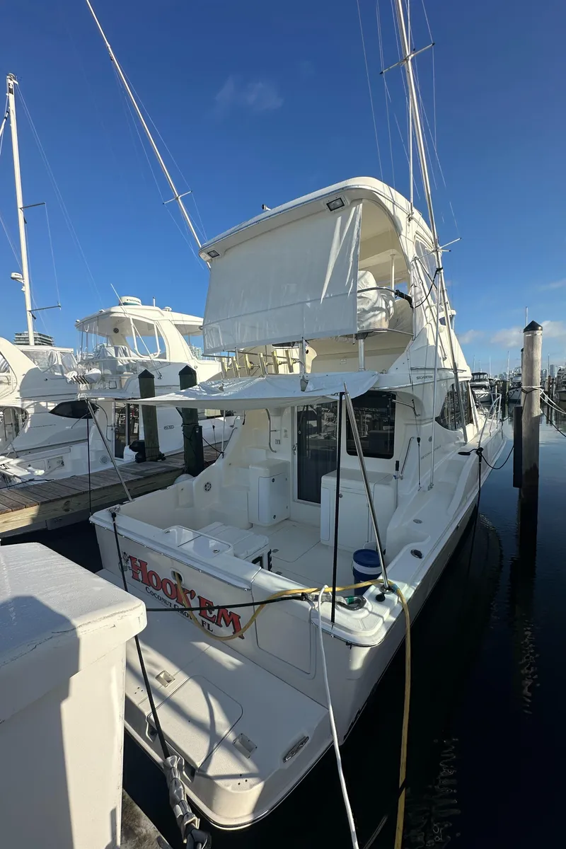 Slide: The Image of 2007 Silverton 38 Convertible yacht docked at marina under clear blue sky. - 27
