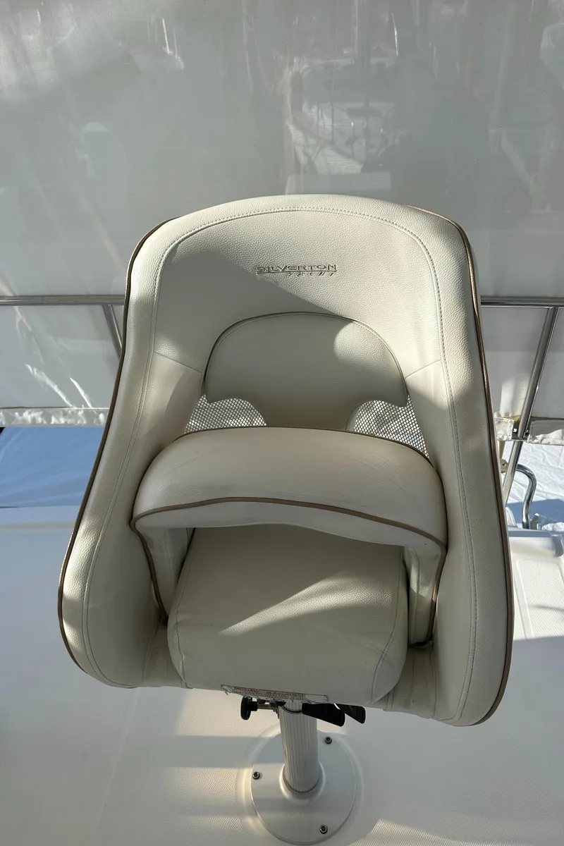 Slide: The Image of Captain's chair on 2007 Silverton 38 Convertible yacht, white leather upholstery. - 29