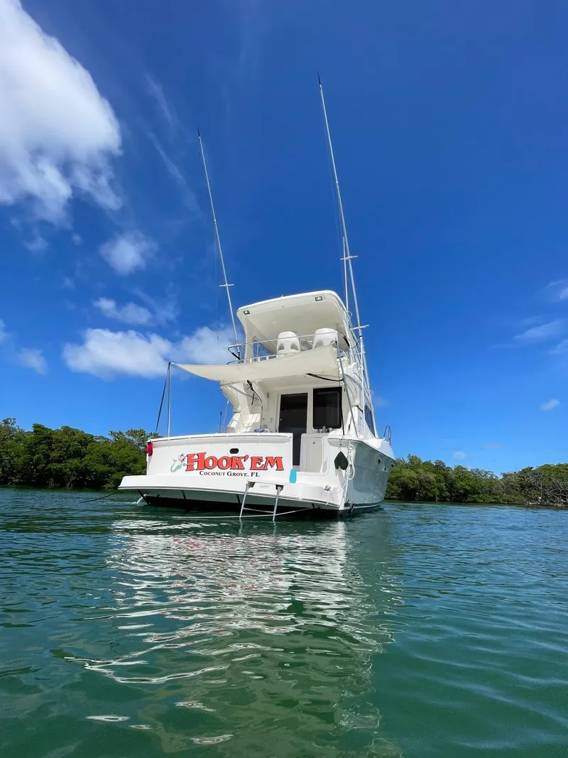 Slide: The Image of 2007 Silverton 38 Convertible yacht on clear water under blue sky. - 3