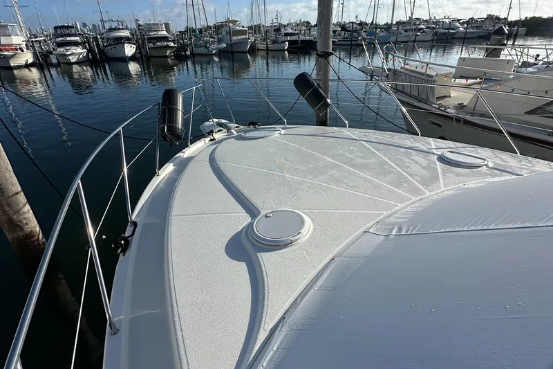 Slide: The Image of 2007 Silverton 38 Convertible yacht docked in marina, surrounded by other boats. - 31