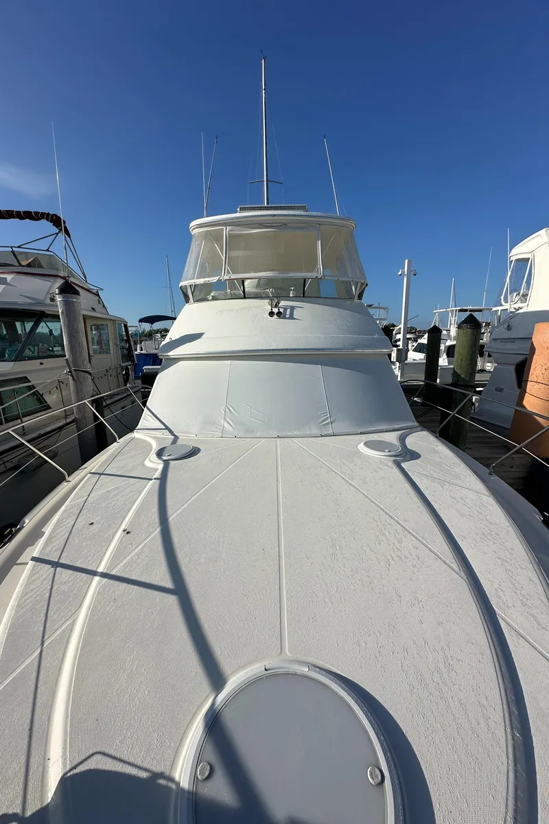 Slide: The Image of 2007 Silverton 38 Convertible yacht docked under clear blue sky. - 32