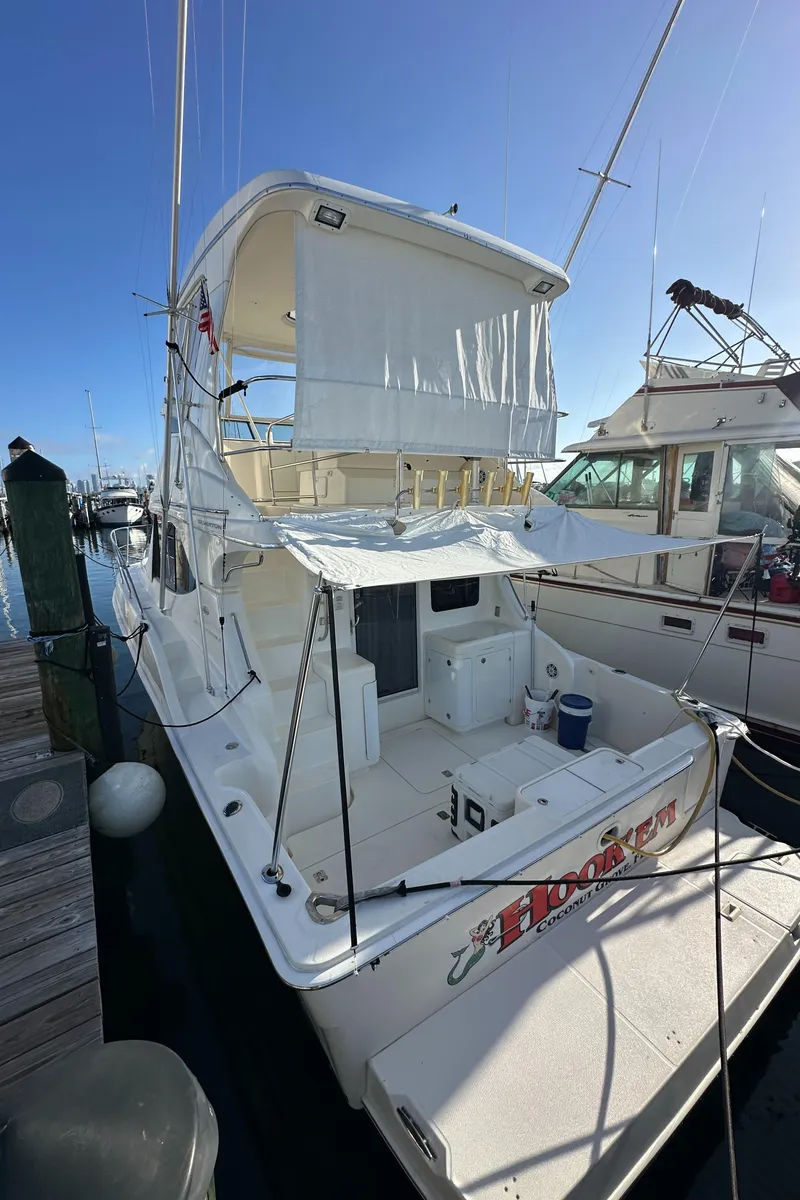 Slide: The Image of 2007 Silverton 38 Convertible yacht docked at marina under clear blue sky. - 34
