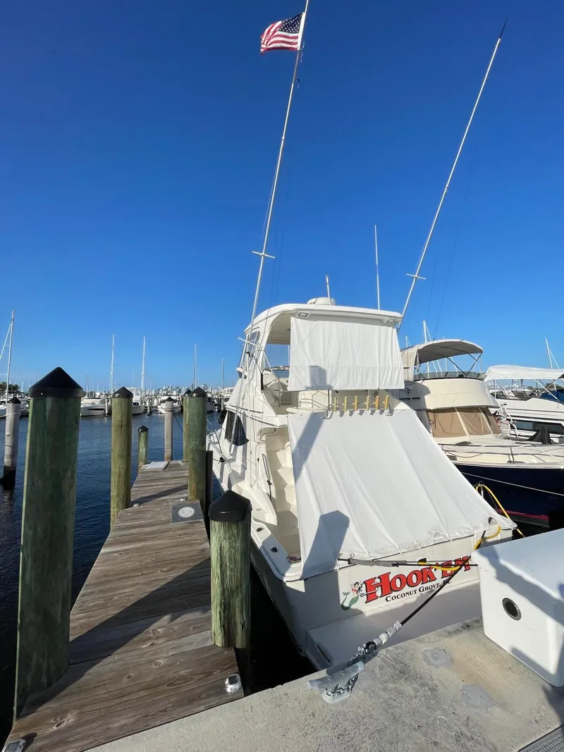 Slide: The Image of 2007 Silverton 38 Convertible docked at marina under clear blue sky. - 9