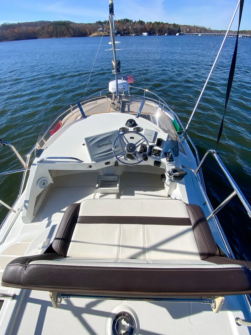 Slide: The Image of 2017 Ranger Tugs R-29 CB boat helm on calm water. - 10