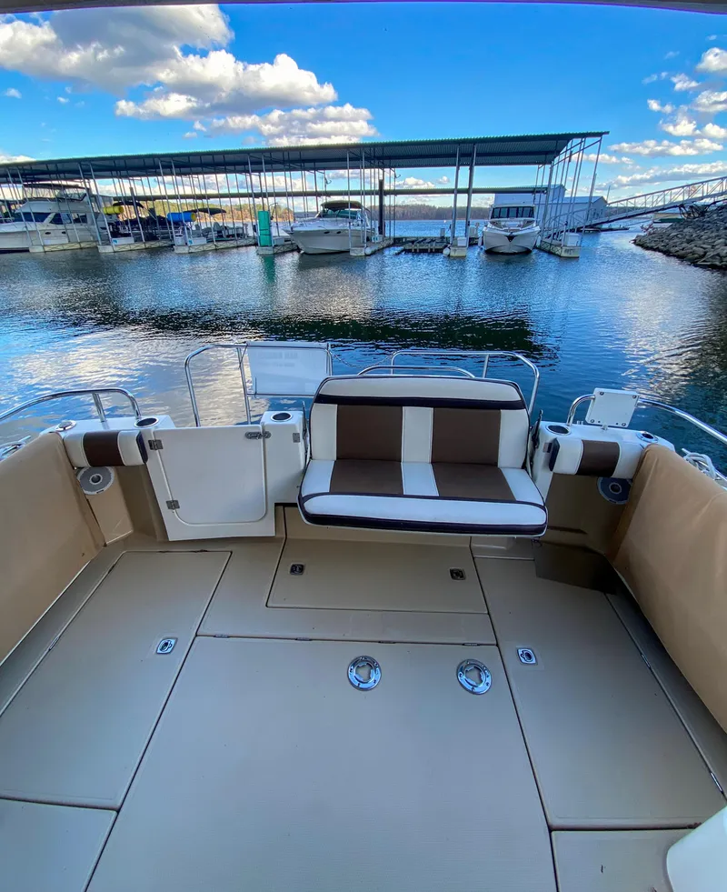 Slide: The Image of 2017 Ranger Tugs R-29 CB boat interior with marina view, featuring spacious seating and calm waters. - 14