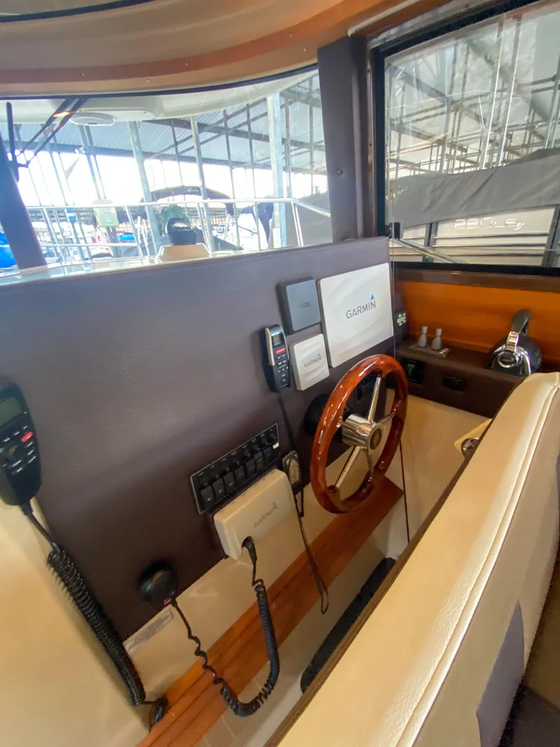 Slide: The Image of 2017 Ranger Tugs R-29 CB helm with Garmin navigation and wood steering wheel. - 19
