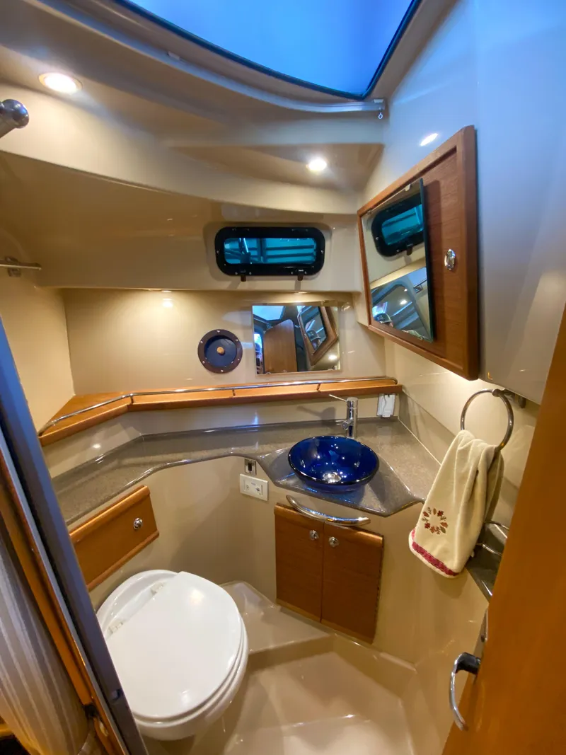 Slide: The Image of 2017 Ranger Tugs R-29 CB bathroom with modern fixtures and blue glass sink. - 20