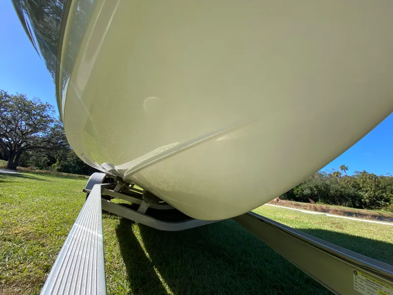 Slide: The Image of 2018 Tidewater 2400 Bay Max boat on trailer, grassy area, clear blue sky. - 10