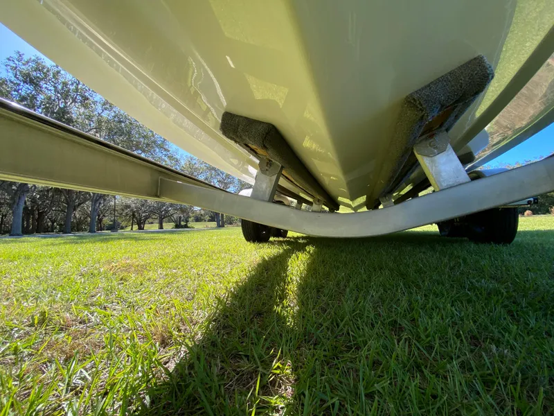 Slide: The Image of Underneath view of 2018 Tidewater 2400 Bay Max boat on grassy field. - 11