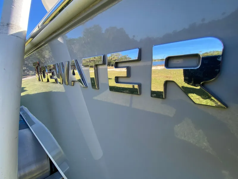 Slide: The Image of 2018 Tidewater 2400 Bay Max boat with reflective logo in sunlight. - 13