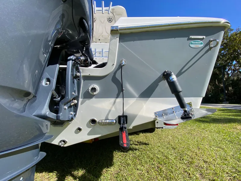 Slide: The Image of 2018 Tidewater 2400 Bay Max boat stern, showcasing trim tabs and motor mount. - 16
