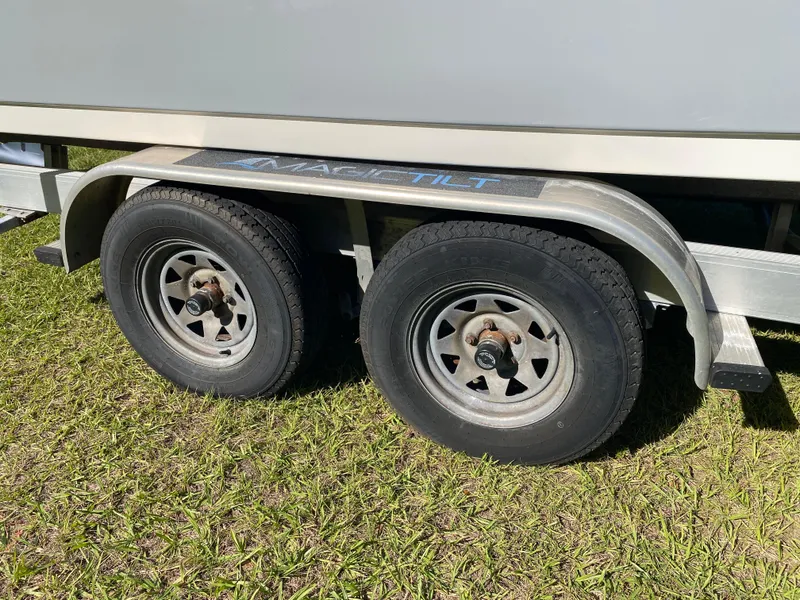 Slide: The Image of Trailer wheels of a 2018 Tidewater 2400 Bay Max boat on grass. - 20