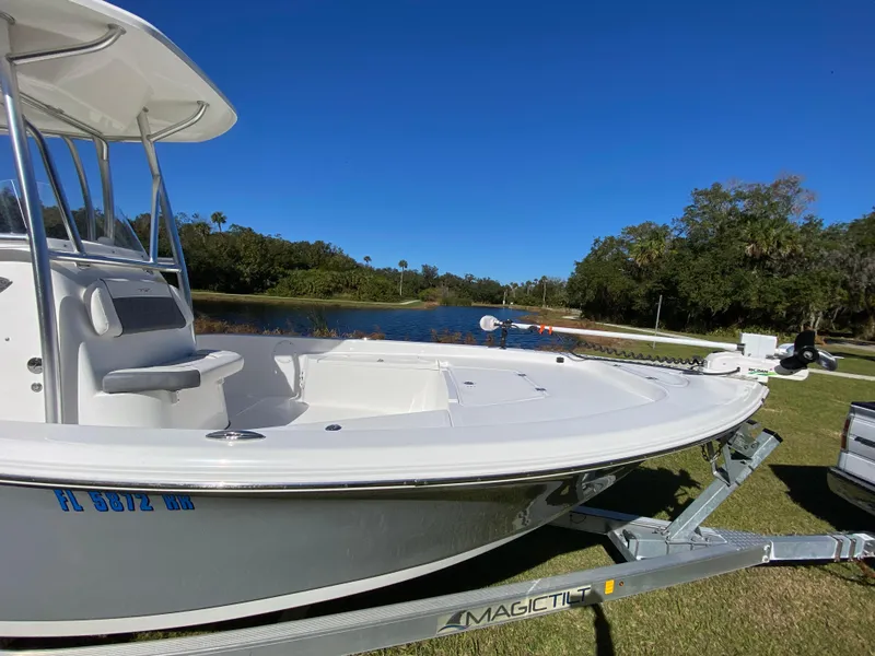 Slide: The Image of 2018 Tidewater 2400 Bay Max boat on trailer by a scenic lake. - 25