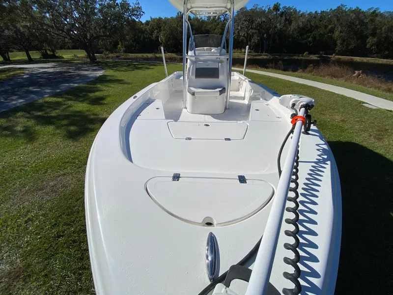 Slide: The Image of 2018 Tidewater 2400 Bay Max boat on grassy area, showcasing deck and console. - 26