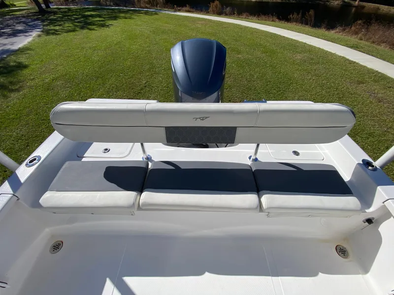 Slide: The Image of 2018 Tidewater 2400 Bay Max boat with cushioned seating and outboard motor. - 30