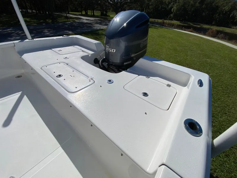 Slide: The Image of 2018 Tidewater 2400 Bay Max boat with Yamaha outboard motor on grassy area. - 31