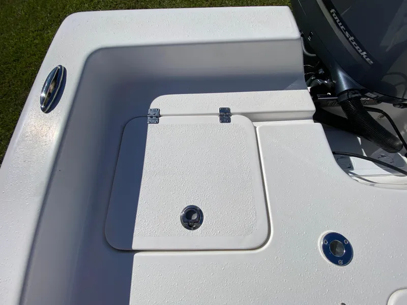 Slide: The Image of 2018 Tidewater 2400 Bay Max boat deck with storage compartment and motor detail. - 38