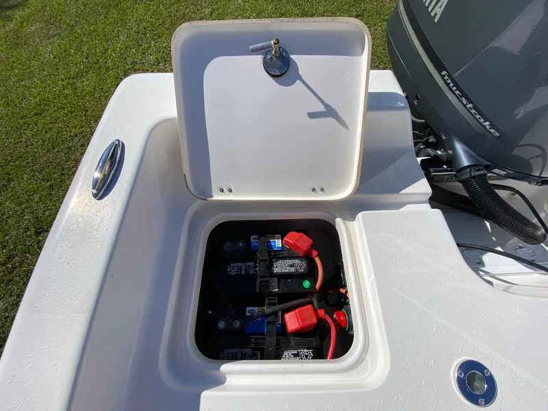 Slide: The Image of 2018 Tidewater 2400 Bay Max boat battery compartment with open hatch. - 40