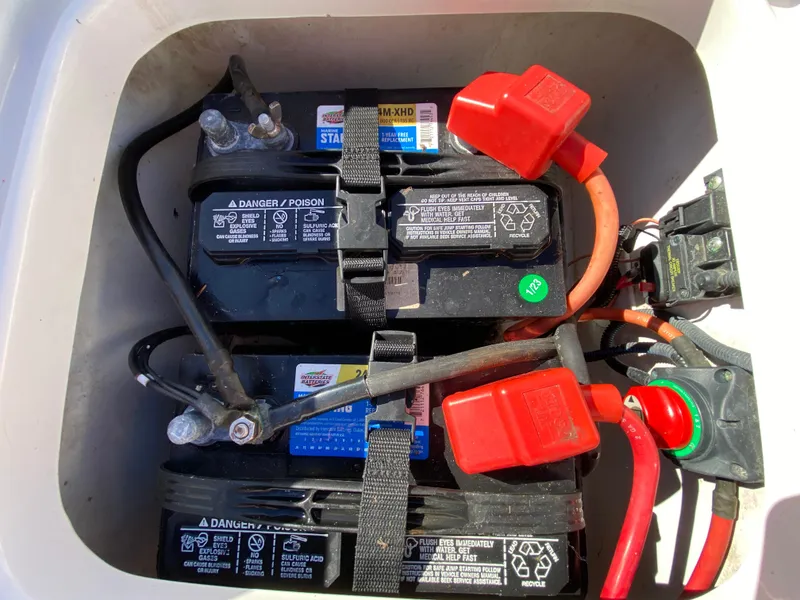 Slide: The Image of 2018 Tidewater 2400 Bay Max boat battery compartment with dual batteries and wiring. - 41