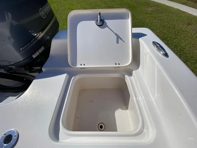 Slide: The Image of 2018 Tidewater 2400 Bay Max boat with open storage compartment and Yamaha engine. - 44