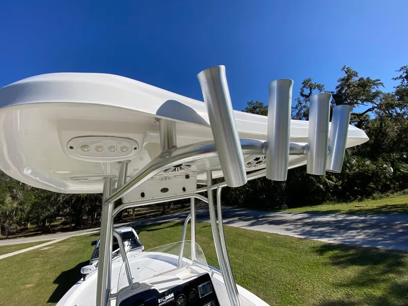 Slide: The Image of 2018 Tidewater 2400 Bay Max boat with T-top and rod holders under clear blue sky. - 46