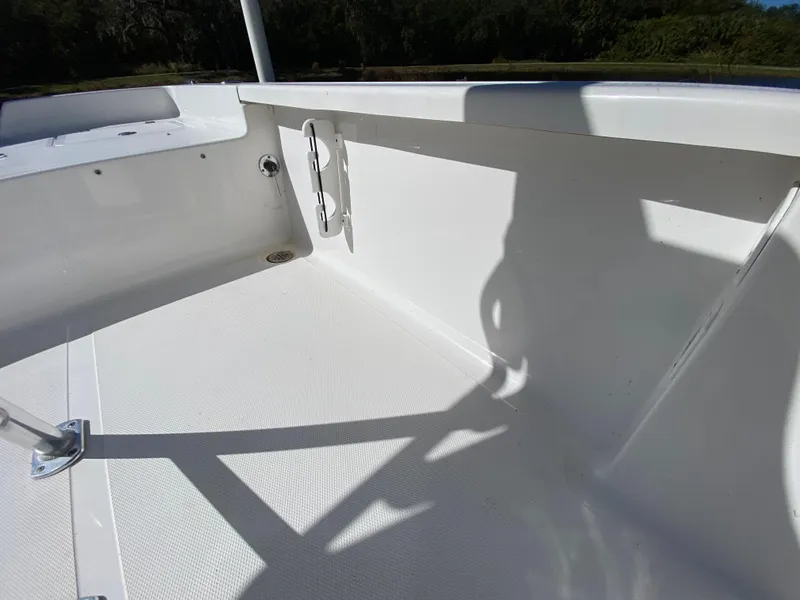 Slide: The Image of 2018 Tidewater 2400 Bay Max boat interior, showcasing clean white deck and side panel. - 48