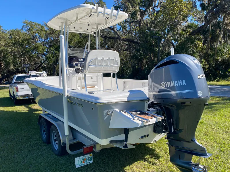 Slide: The Image of 2018 Tidewater 2400 Bay Max boat with Yamaha engine on trailer, parked on grass. - 5