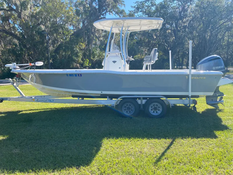 Slide: The Image of 2018 Tidewater 2400 Bay Max boat on trailer, parked on grass, under sunny skies. - 6
