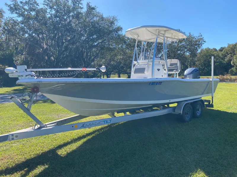 Slide: The Image of 2018 Tidewater 2400 Bay Max boat on trailer, parked on grass under clear sky. - 7