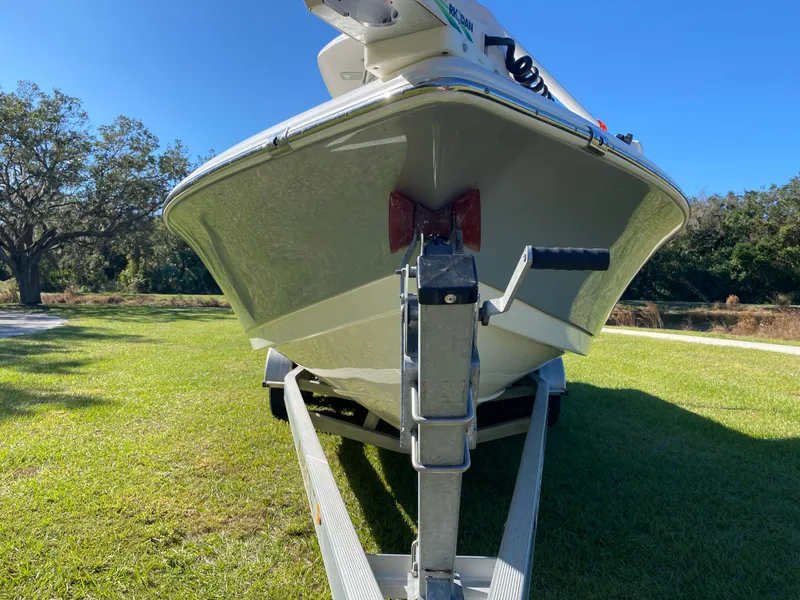 Slide: The Image of 2018 Tidewater 2400 Bay Max boat on trailer, parked on grass under clear blue sky. - 8