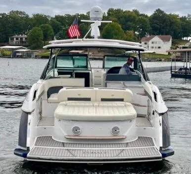 The Image of 2017 Cobalt A40 boat on a lake with American flag, rear view. - 0