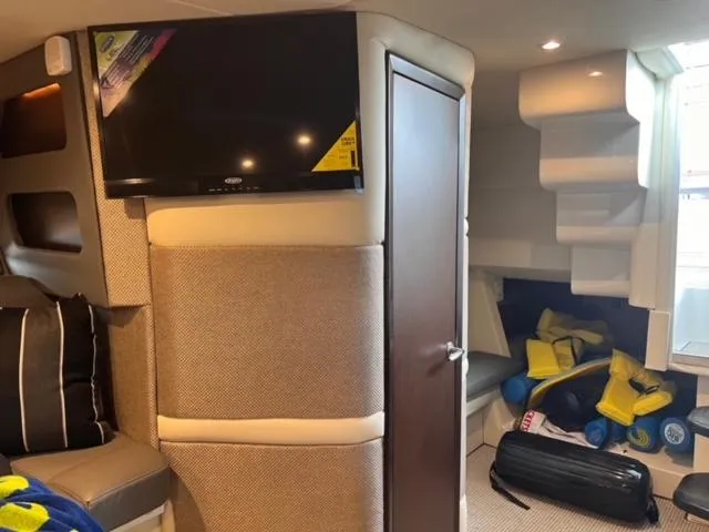 Slide: The Image of Interior of 2017 Cobalt A40 boat with TV, storage, and seating area. - 12