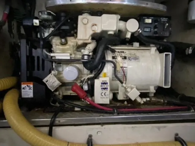 Slide: The Image of Engine compartment of a 2017 Cobalt A40 boat, featuring mechanical components and wiring. - 19