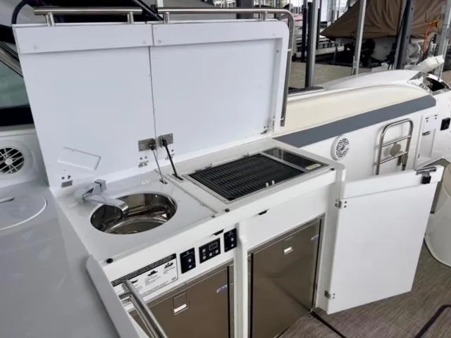 Slide: The Image of Outdoor kitchen on a 2017 Cobalt A40 boat with grill and sink. - 3