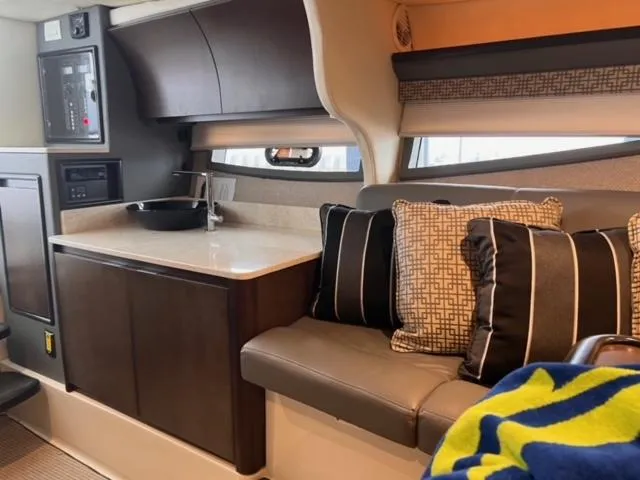 Slide: The Image of 2017 Cobalt A40 yacht interior with modern kitchenette and cozy seating area. - 9