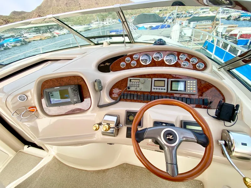 Slide: The Image of Helm of 2000 Sea Ray 380 Sundancer with navigation instruments and steering wheel. - 14