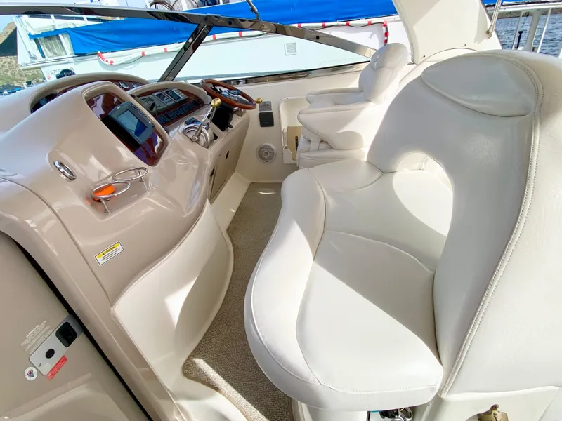 Slide: The Image of Interior of 2000 Sea Ray 380 Sundancer yacht with white leather seating and control panel. - 18