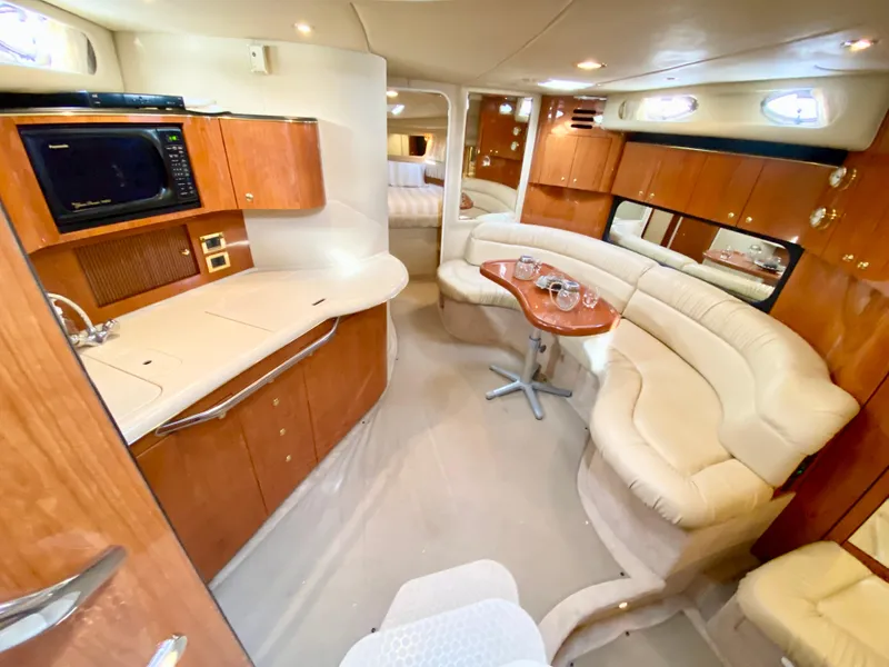 Slide: The Image of Luxurious interior of 2000 Sea Ray 380 Sundancer yacht with elegant seating and kitchenette. - 22