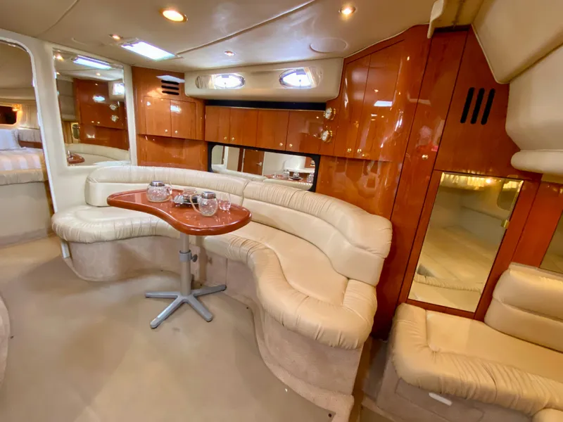 Slide: The Image of Luxurious interior of 2000 Sea Ray 380 Sundancer yacht with plush seating and wooden accents. - 23